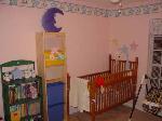 One side of the finished baby room.  That crib is 60 years old!