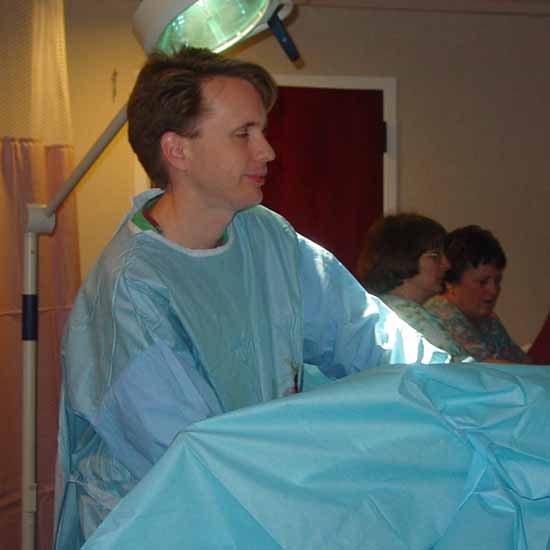 Here is a picture of Dr. Inge, our OB.  He's cleaning up the mess that Adrienne made of herself.