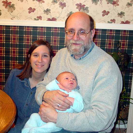 Emily with her mommy and Grandpa Bill.