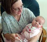 Here is Emily in the midst of her first feeding.  Rice cereal!  Yum!