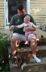 Daddy, Emily, and Ripley in front of Grandma Jan's house.