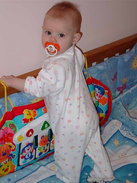 Emily standing in her crib.