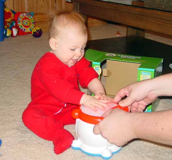 Playing with her new drum.