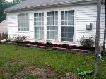 This is the flower bed along the back of the house.  We planted bushes because flowers are too much work.