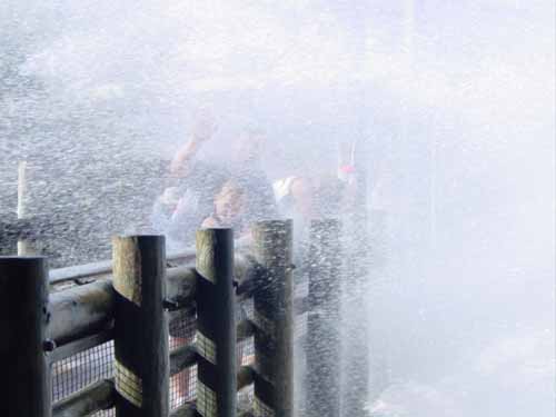 If you look closely, you can see Samantha and I barely.  This is over a bridge, also known as a ''water attraction.''  We're getting <B>very</B> wet here.